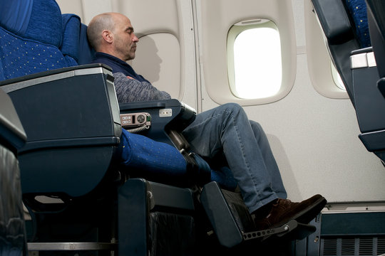commercial airline passenger sitting inside the plane