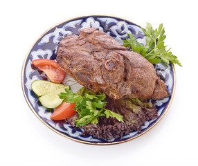 Meat on a grill with vegetables