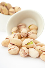 Fototapeta premium Heap of pistachios nuts isolated on the white