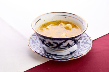 Bowl of chicken soup with vegetables and noodles