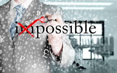 Businessman Hand turning the word Impossible into Possible with