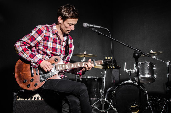 Man with guitar during concert