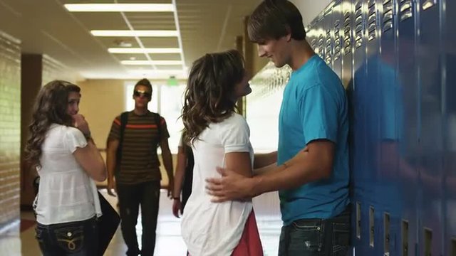 MS Teenage couple (14-17) embracing in school corridor / Spanish Fork City, Utah, USA