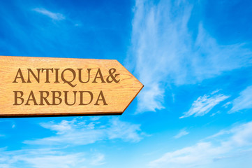 Wooden arrow sign pointing destination ANTIQUA and BARBUDA