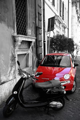 Red tiny car at the city street, Rome, Italia