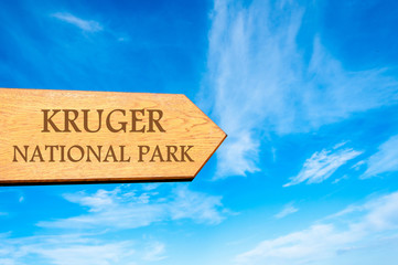 Wooden arrow sign pointing destination KRUGER NATIONAL PARK