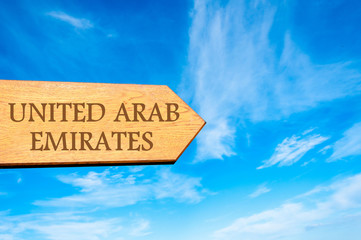 Wooden arrow sign pointing destination UNITED ARAB EMIRATES