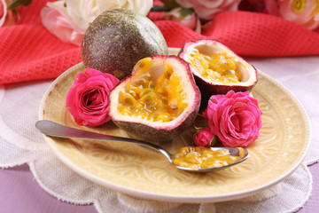 Passion fruit on plate on color wooden background