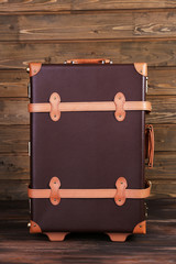 Suitcase on wooden background