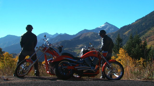 two motorcyclists making a pit stop