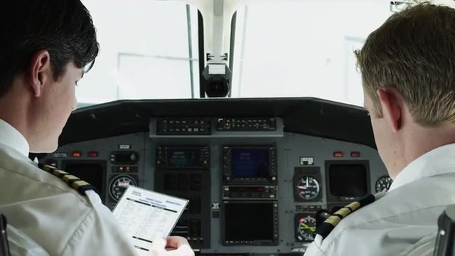 CU TD Rear view of two pilots in airplane cockpit / Spanish Fork, Utah, USA