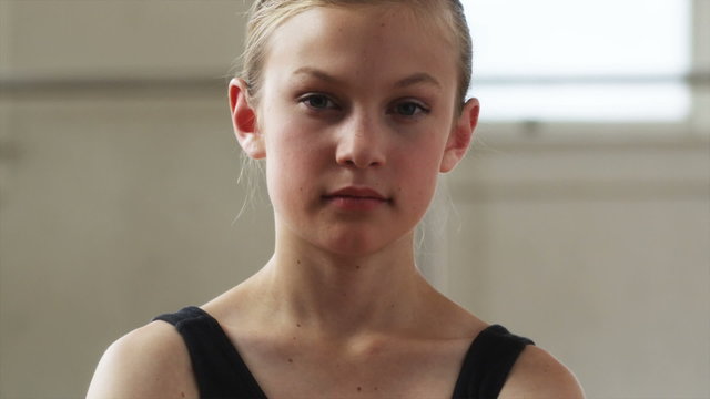 young ballerina looking at camera