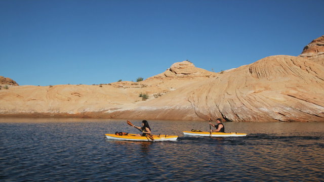 two kayakers on a desert lake