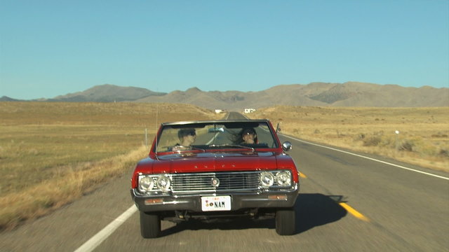 vintage red convertible driving