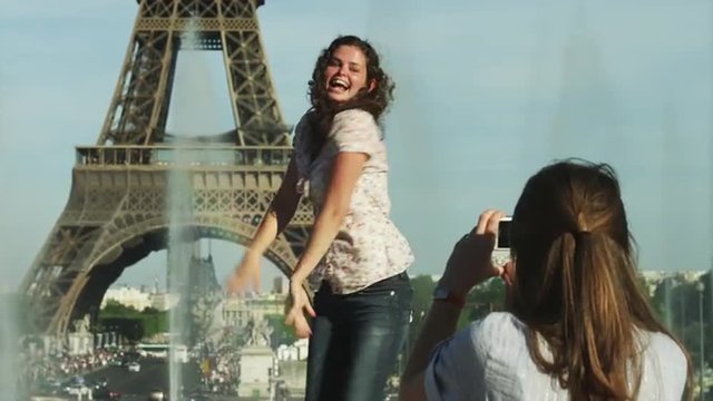 MS Young women taking photos in front of Eiffel Tower / Paris, France