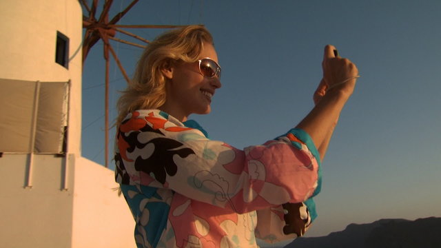 A woman taking a picture in Mykonos