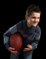 Young Boy Posing With Football