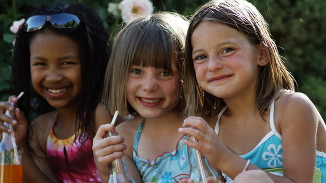 three girls drinking soda pops
