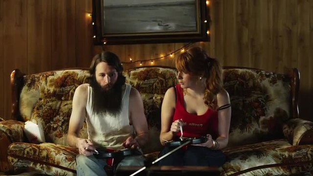 MS TD Couple eating take away food on sofa at Christmas/ Orem, Utah, USA