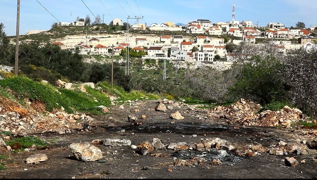 Road blocked with rocks after conflict between Jews and Arabs