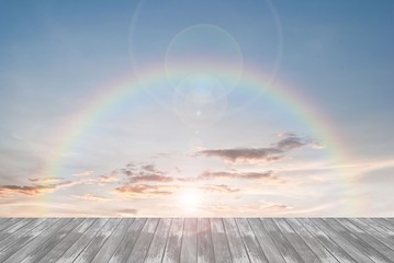 old wooden texture and rainbow  with lens flare in blue sky 