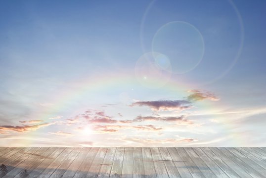 old wooden texture and rainbow with lens flare in blue sky
