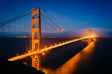 Fototapeta na wymiar Night view of the Golden Gate Bridge and fog from Battery Spence