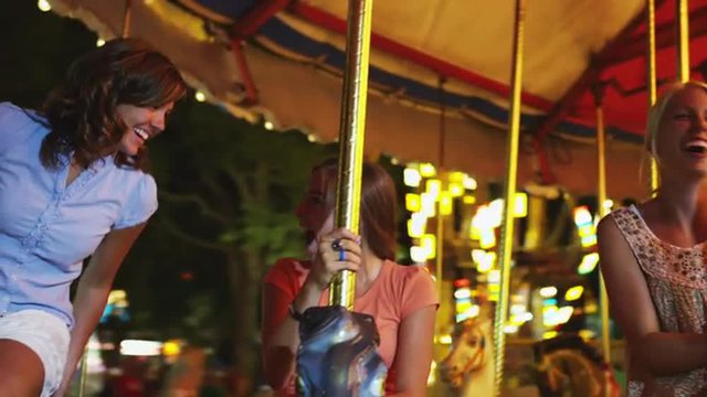 MS POV Girls (16-17) riding carousel in amusement park / American Fork City, Utah, USA