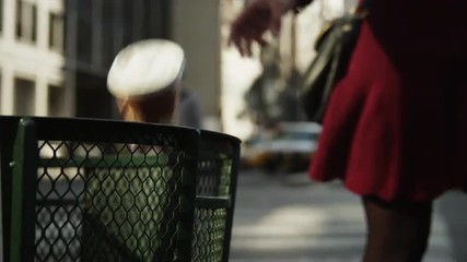 Close up slow motion of woman throwing coffee cup in city garbage can / New York City, New York, United States