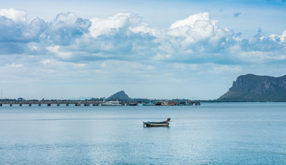 Obraz premium The seascape view of boats, concrete pier and mountain island