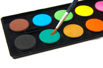 Watercolor green paint and brush on a white background