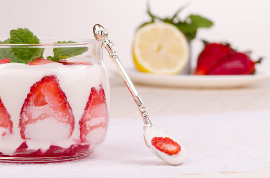 Strawberry dessert with spoon on the kitchen table