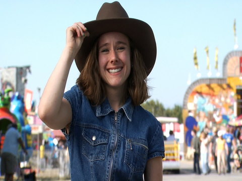 Woman posing with cowboy hat