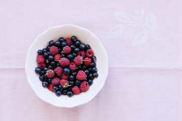 Mix of wild rapberry and black currant in pastel pink bowl