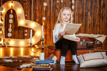 little girl holding a note in vintage interior