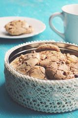 Homemade almond meringue cookies with walnuts on blue background