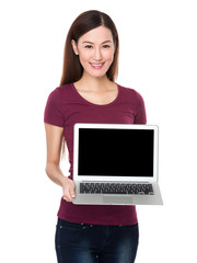 Asian woman show with blank screen of laptop computer