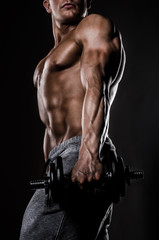 Fototapeta na wymiar Powerfull Athlette Posing with weights