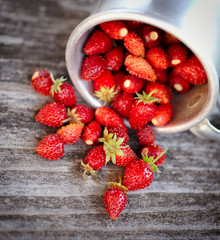 Fresh wild strawberries on an old wooden table