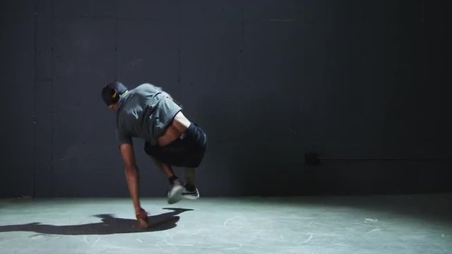 WS Studio shot of young man breakdancing