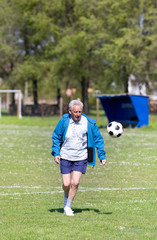 Old man playing football