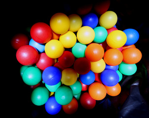 colored balls inside the big bag black