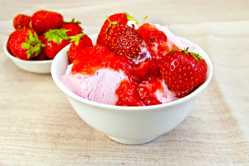 Ice cream strawberry in bowl on fabric