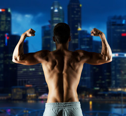 Fototapeta na wymiar young man or bodybuilder showing biceps