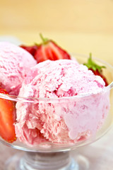 Ice cream strawberry in glass bowl on board