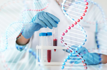 close up of scientist with tube making test in lab