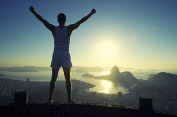 Fototapeta premium Athlete Standing Arms Raised Rio de Janeiro Sunrise