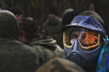 paintball player in protective uniform and mask - obrazy, fototapety, plakaty