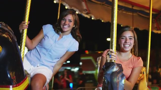 MS POV Girls (16-17) riding carousel in amusement park / American Fork City, Utah, USA