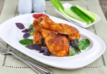 Crisp crunchy golden chicken legs with basil and tomato sauce